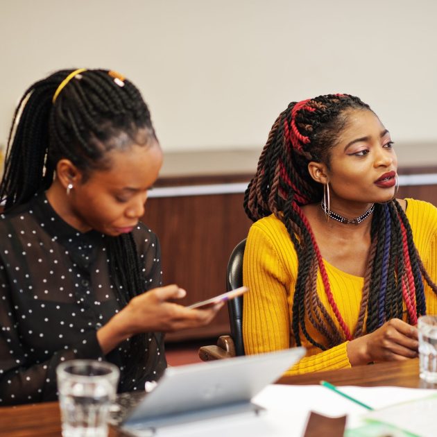 African american women colleagues, crew of divercity female partners in office sit at the table.
