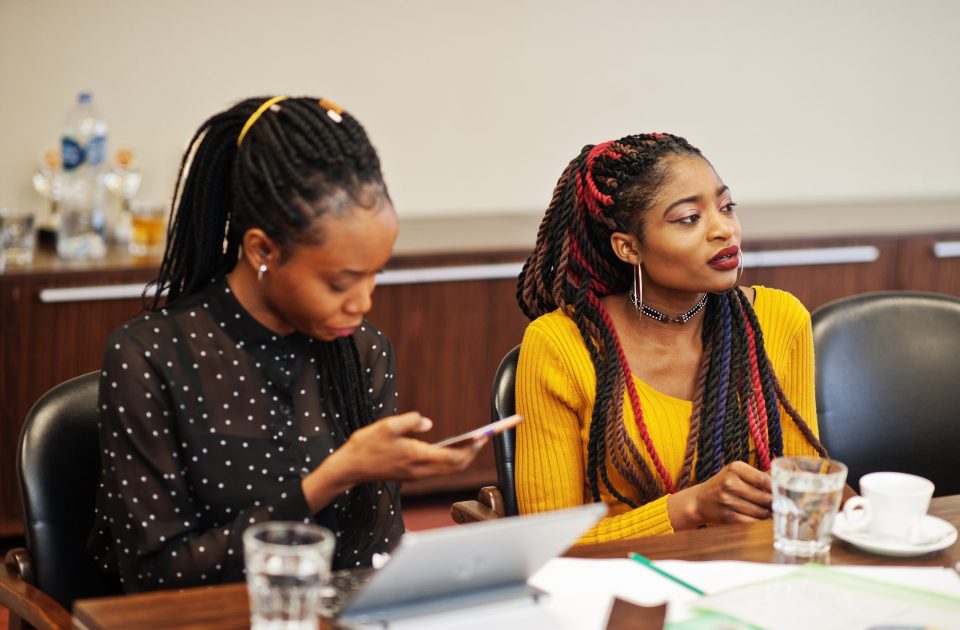 African american women colleagues, crew of divercity female partners in office sit at the table.